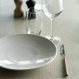 Elements dining table - varnished Microcement - Off White - round White Cliff Studio Dining Table