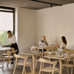 Torsion dining table - varnished oak - round White Cliff Studio Dining Table